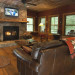 Nantahala River Lodge spacious living room with comfortable leather furniture and a wood burning fireplace